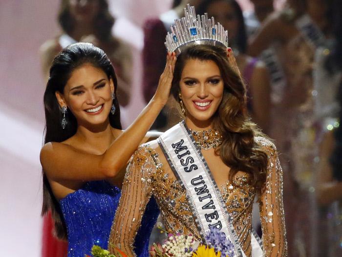 Iris Mittenaere of France is crowned the new Miss Universe 2016 by 2015 Miss Universe Pia Wurtzbach in coronation Monday, Jan. 30, 2017, at the Mall of Asia in suburban Pasay city, south of Manila, Philippines.