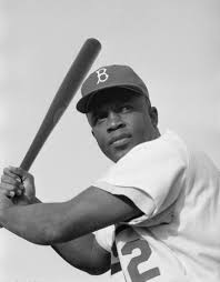 Jackie Robinson poses with a bat in 1954 during his time as a Brooklyn Dodger.
