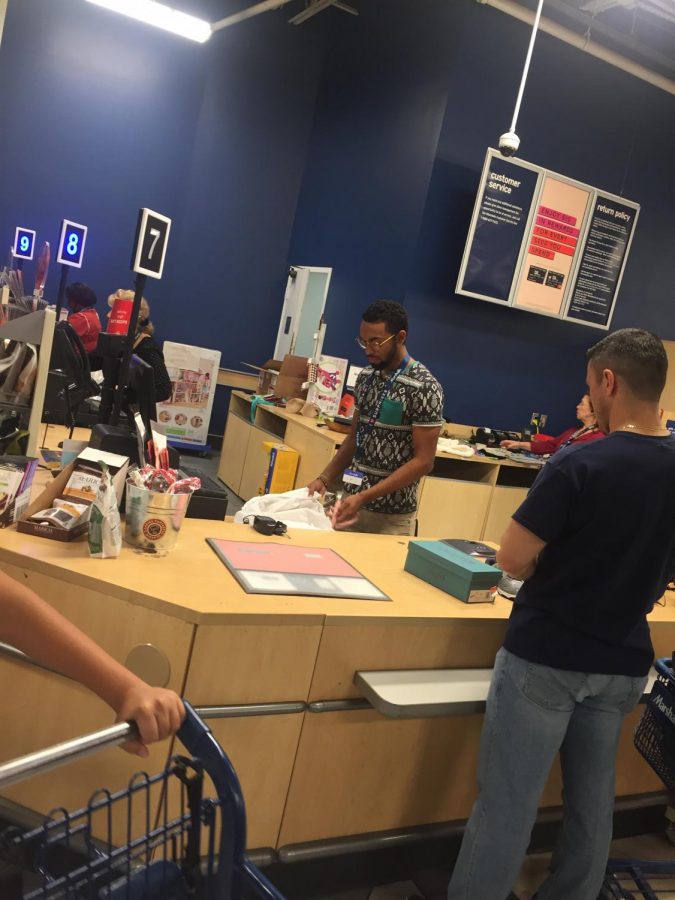 Senior Jaiden Moses checks out a customer during a shift at Marshalls. 