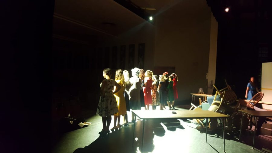 The cast is backlit by lighting directors Cory Gershengorn and Frankie Ferrer during the Nov. 7 dress rehearsal to emphasize the tension of the scene.