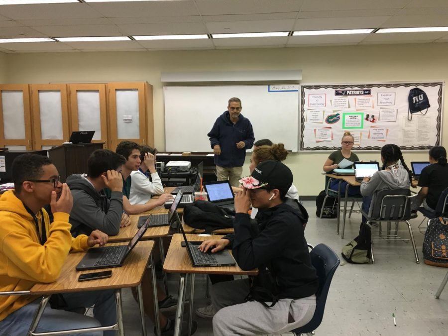 Dual Enrollment teacher of ENC1101/ENC1102, Dale Mahfood, instructs his class as it works on a college-level assignment.
