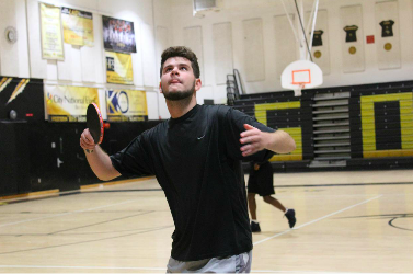 Club founder Noah Rosenthal puts his game face on as he serves the ball to a fellow club member at an April meeting.