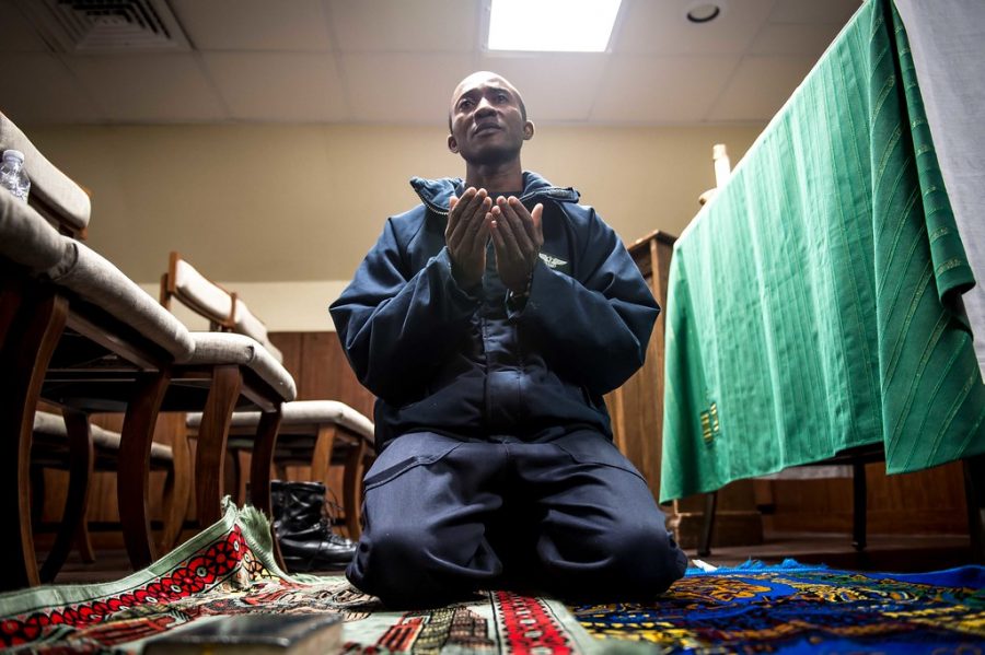 On board the aircraft carrier the USS Theodore Roosevelt, Abdul N. Alassan practices the Islamic faith during a prayer service held in the ship’s mosque. As immigration detention centers face controversy on the conditions that their Muslims inmates are being kept many worry about the continuation of violating religious rights. 