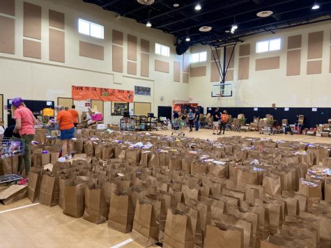 Harvest Drive volunteers pack bags for family pickup on Nov. 19 in the mini gym.
