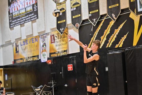 Junior Cole Esterline serves the ball into play against Cardinal Gibbons on March 7. 